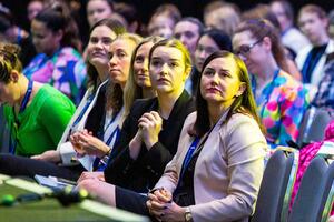 Rows of attendees watching a presentation, the 2024 CPAC sitting in the first row.
