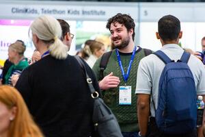 Attendees chatting in the exhibition hall