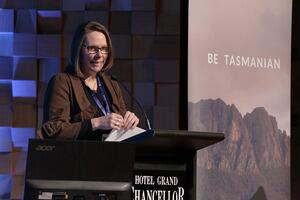 2023 Conference Convener, Harmony Turnbull, presenting at a lectern. 