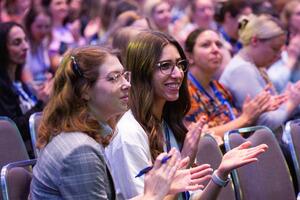 Attendees applauding during a presentation