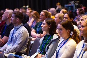Rows of attendees watching a presenter