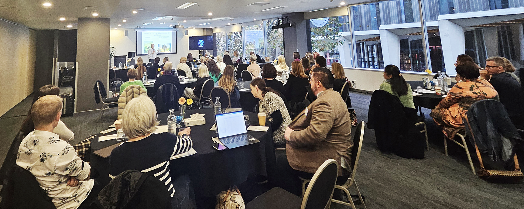This is a photo of a room full of participants of the Futures Workshop actively listening to the presentation.